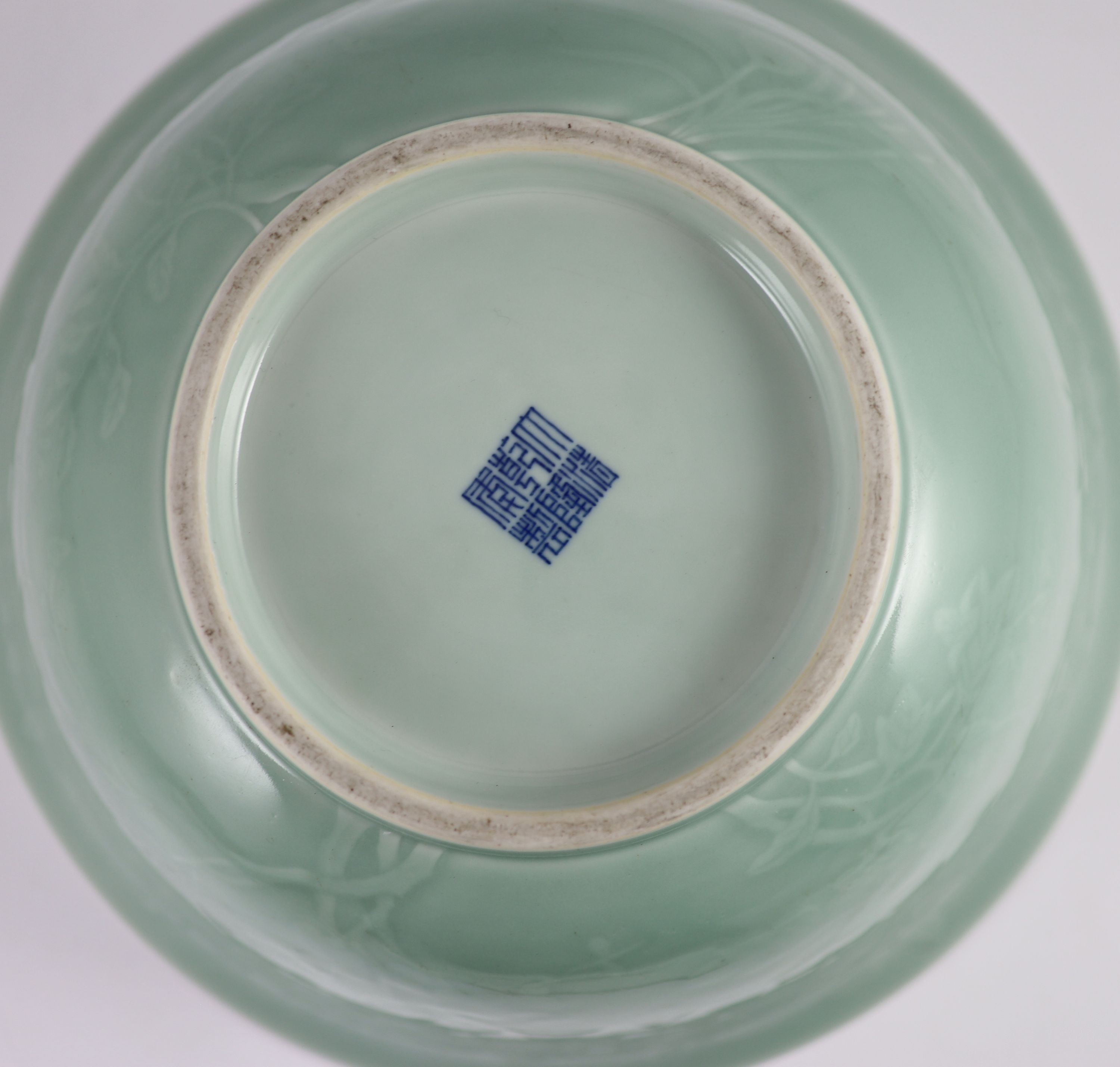 A fine large Chinese moulded celadon-glazed bowl, Qianlong seal mark and of the period (1736-95), Rim 33.6mm diameter, 16.5cm high, foot 16cm diameter